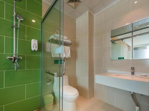a bathroom with a shower and a toilet and a sink at GreenTree Inn Qinhuangdao Changli County Guangyuan Life Square Duanyang Street East Section in Qinhuangdao