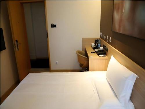 a hotel room with a bed and a desk at IU Hotel Chengdu High-Tech Zone Longhu Times Street in Chengdu