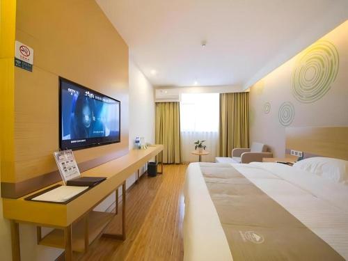 a hotel room with two beds and a flat screen tv at GreenTree Inn Beijing Shunyi Fengbo Metro Station in Beijing