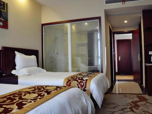 a hotel room with two beds and a window at GreenTree Inn Shanghai Jiading Newtown MaLu Subway Station Business Hotel in Jiading