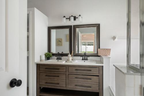a bathroom with two sinks and a mirror at Chic & Cozy Hideaway in Davenport