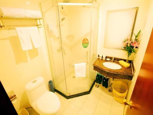 a bathroom with a shower and a sink and a toilet at GreenTree Alliance Changzhou University City Hotel in Changzhou