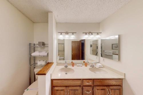 een badkamer met twee wastafels en een grote spiegel bij Lakeside Bliss in Hot Springs