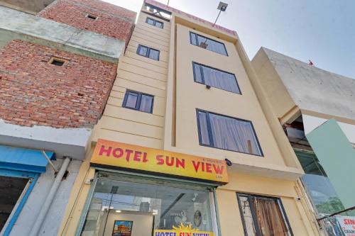 a hotel with a sign in front of a building at Hotel O Sun View in Ludhiana