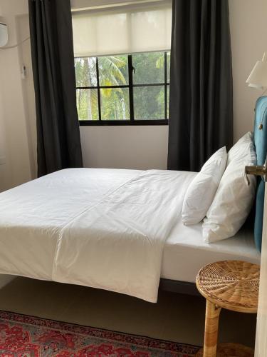 a bedroom with a white bed with a window at 3 BDR new Apartment in PORT BARTON in San Vicente
