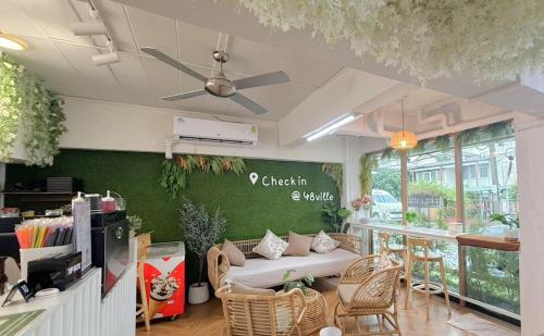 a living room with a couch and some chairs at 48 Ville Donmuang Airport in Bangkok