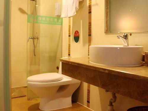 a bathroom with a sink and a toilet and a shower at GreenTree Inn Nanning Langdong Hotel in Nanning