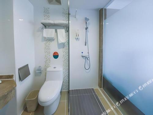 a bathroom with a toilet and a shower at GreenTree Inn Nanning Langdong Hotel in Nanning