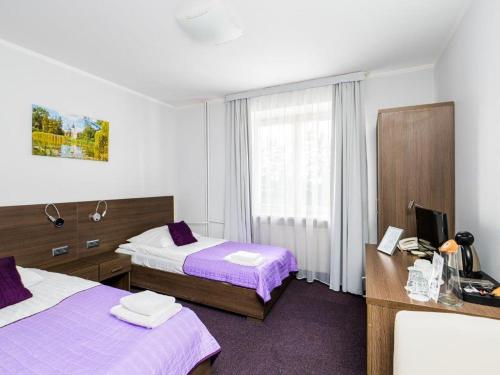 Postel nebo postele na pokoji v ubytování Zamek w Baranowie Sandomierskim