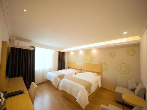 Ένα ή περισσότερα κρεβάτια σε δωμάτιο στο GreenTree Inn Qingyuan Qinghe Avenue Branch