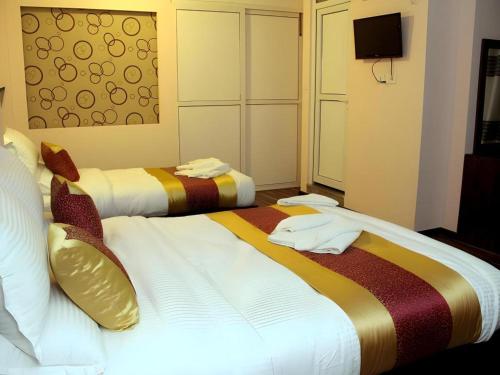 Postel nebo postele na pokoji v ubytování De Hotel Veda