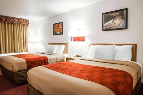 a hotel room with two beds in a room at Econo Lodge Truman Inn in Sedalia