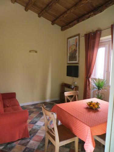 sala de estar con mesa roja y sillas en Junior Suite Cattedrale, en Palermo
