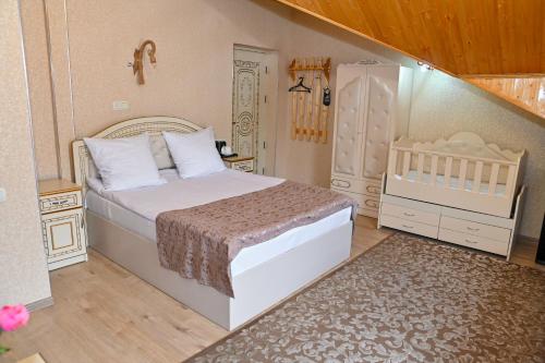 a small bedroom with a bed and a staircase at Har-Mar Hotel in Goris