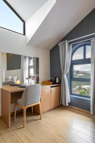 a room with a desk and a window at Gold View Boutique Hotel Đà Lạt in Da Lat