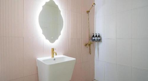 a bathroom with a urinal and a shower with wine bottles at Gallery Pension in Taean