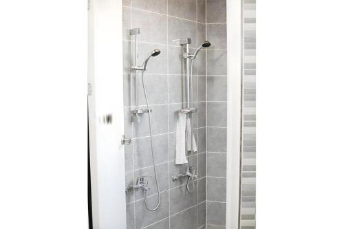 a shower in a bathroom with a shower curtain at Capsule Inn Gangneung in Gangneung