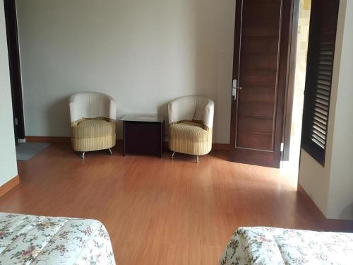 two chairs and a table in a room at Fafa Hill Hotel and Resort in Bogor