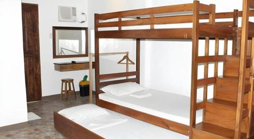 two bunk beds in a room with a mirror at Anda de Boracay in Bohol Hotel in Anda