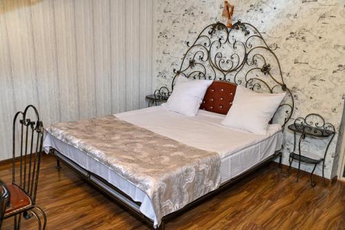 a bedroom with a bed with a wrought iron headboard at Har-Mar Hotel in Goris
