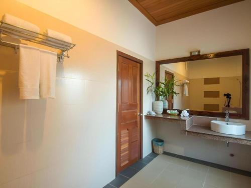 a bathroom with a sink and a mirror at Sambopich Chenla Hotel in Kompong Thom
