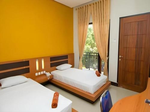 Postel nebo postele na pokoji v ubytování Hotel New Melati