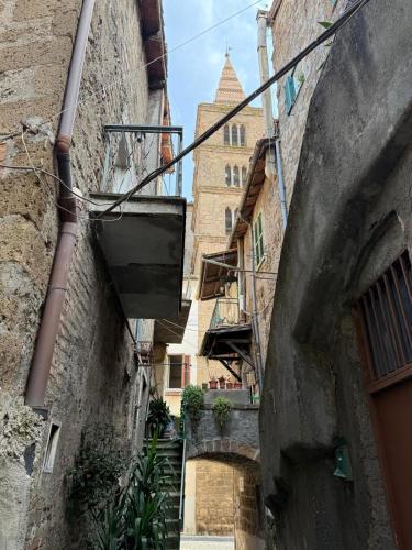 an alley between two buildings with a building in the background at Gabriella's in Capranica