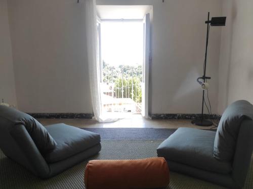 a living room with a couch and a large window at Gabriella's in Capranica