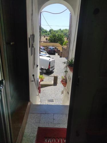 an open door with a car parked in a parking lot at Gabriella's in Capranica