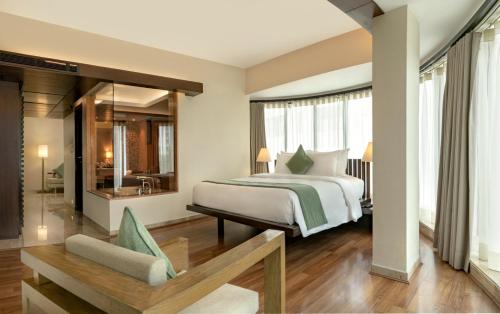 a hotel room with a bed and a bathroom at The Mirador in Mumbai