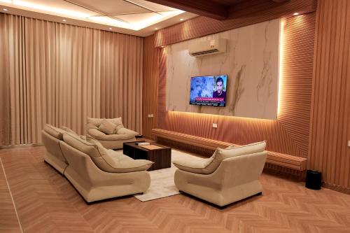 a waiting room with chairs and a flat screen tv at منتجع صلالة دريم لاند Salalah Dreamland Resort in Salalah