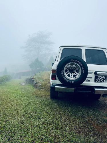 a white truck parked on the side of a road at Royal Mountain Edge ,Knuckles in Rangala