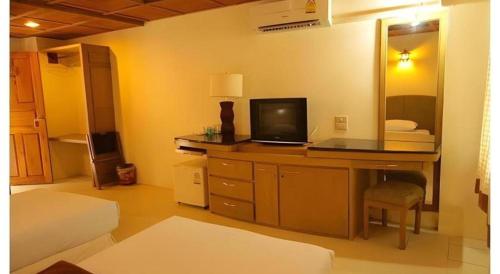 a bedroom with a desk with a laptop on it at Panorama Hotel in Mae Hong Son