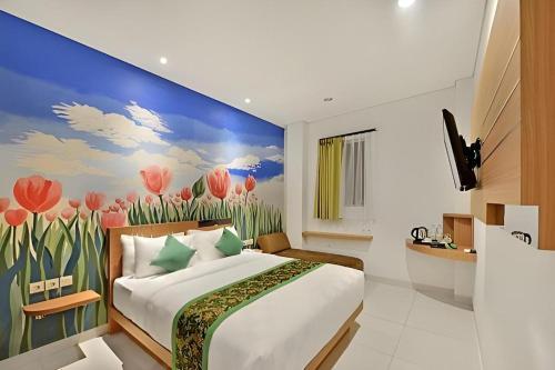 a bedroom with a bed and a painting of tulips at Lotus Hotel Subang in Bandung