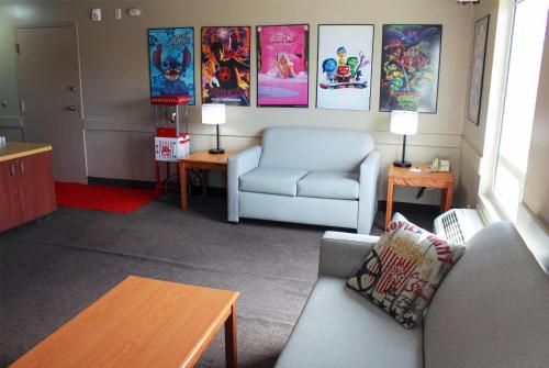 a living room with a couch and a chair at Super 8 by Wyndham Edmonton South in Edmonton