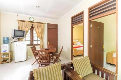 a living room with a table and a room with a bedroom at CICO Resort in Bogor