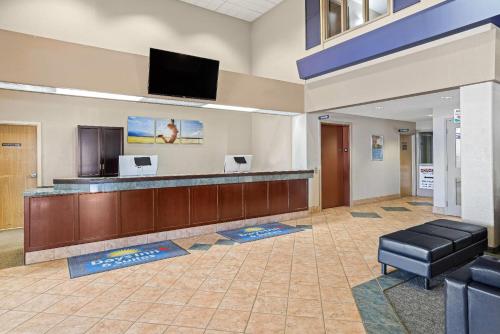 a lobby with a waiting room with a flat screen tv at Days Inn & Suites by Wyndham Winkler in Winkler