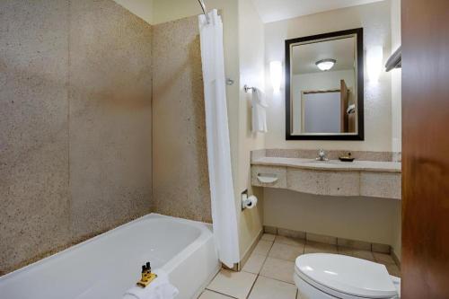 a bathroom with a tub and a toilet and a sink at Best Western Plus Guymon Hotel and Suites in Guymon