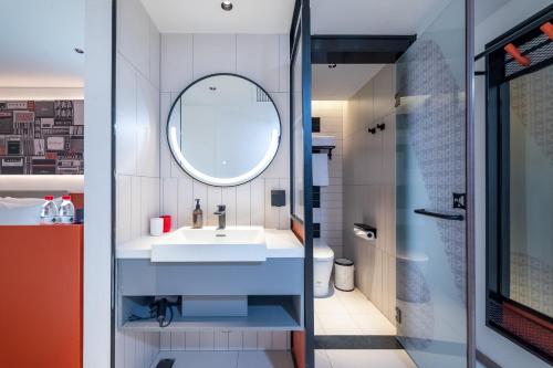 a bathroom with a sink and a mirror at ibis Beijing Tiananmen Square Hotel in Beijing