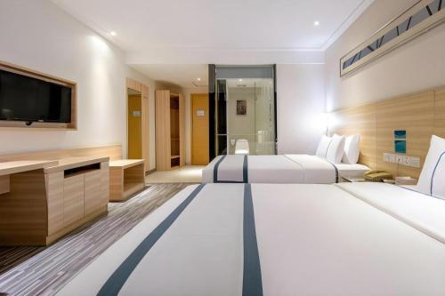 Letto o letti in una camera di City Comfort Inn Nanning Railway Station