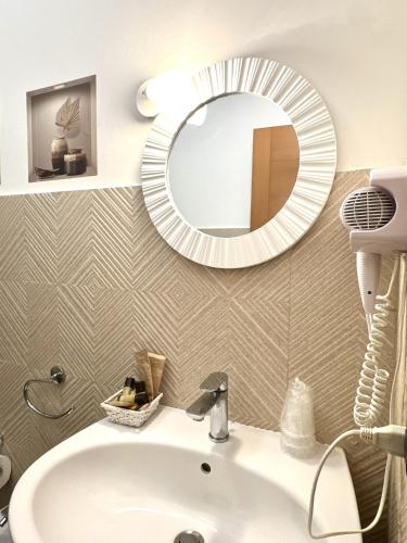 a bathroom with a sink and a mirror on the wall at Hotel Masseria Marziale in Brindisi