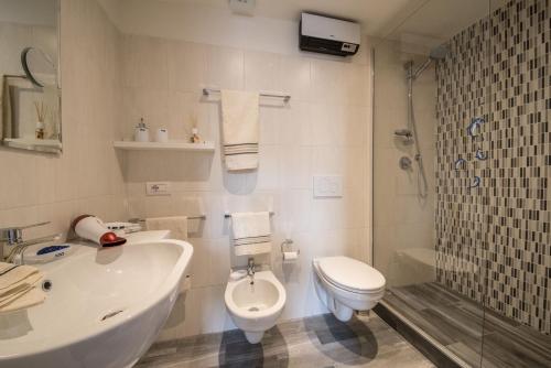 a bathroom with a sink and a toilet and a shower at Casa Balestra in Assisi