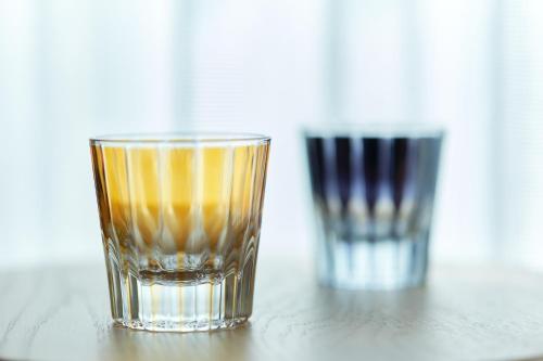 two glasses sitting on top of a table at AQUA RESIDENCE Sangenjaya by Tranova in Tokyo