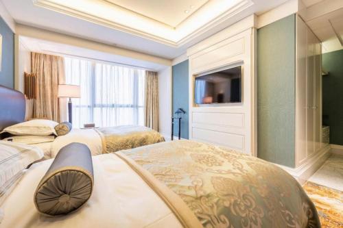 a hotel room with two beds and a television at Xian Jue Vu Hotel in Xi'an