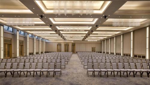 an empty room with rows of chairs in it at Signia by Hilton in Amman