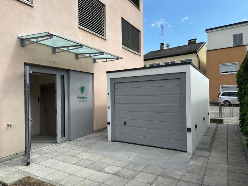 a garage door with a glass roof on a building at Brauhotel Vitzthum in Helpfau-Uttendorf
