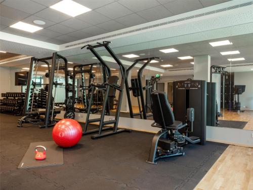 a gym with a red ball and exercise equipment at Hilton Garden Inn Brussels Airport in Diegem