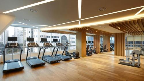 a gym with treadmills and ellipticals in a building at LOTTE City Hotel Myeongdong in Seoul