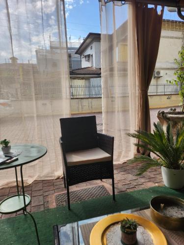 a patio with a chair and a table and a window at Hotel IL Rifugio in Gonzaga