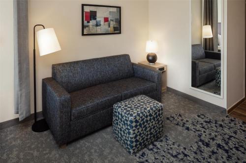 a living room with a couch and a chair at Home2 Suites By Hilton Clearwater St. Petersburg Ulmerton Rd in Clearwater
